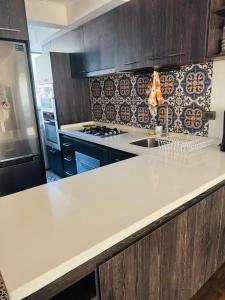 a kitchen with a white counter top in a kitchen at Refugio las pircas in Vicuña