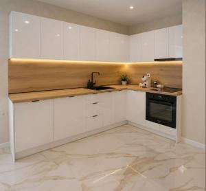 a kitchen with white cabinets and a sink at Nikol River Residence in Sandanski