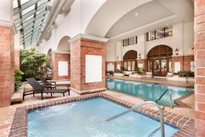 a swimming pool in a large building with a swimming pool at The Signature Suites in Irving
