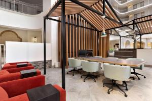 a conference room with a long table and chairs at The Signature Suites in Irving