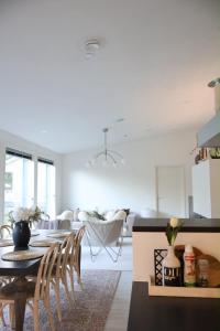 a kitchen and living room with a table and chairs at Villa Lydia Lapland - Private Sauna & Aurora View in Rovaniemi