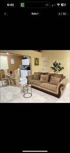 a living room with a couch and a table at Rico Puerto Village cabrera in Cabrera