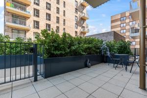 a cat sitting on a patio in front of a building at 2 Bed Flat, Pool Table, Terrace 4 stops to Wembley in Hatch End
