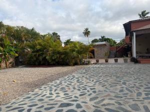 a cobblestone driveway in front of a house at Rico Puerto Village cabrera in Cabrera