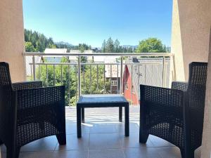a blue table on a balcony with two chairs at Apartman VUKOVIĆ in Žabljak