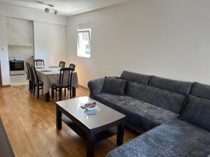a living room with a couch and a table at Apartman VUKOVIĆ in Žabljak