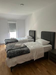 two beds sitting in a room with at Apartman VUKOVIĆ in Žabljak