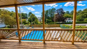 a view from the deck of a swimming pool at Motel Luzerne in Lake Luzerne