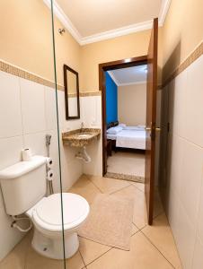 a bathroom with a toilet and a sink at Aura de Cunha in Cunha +13 photos