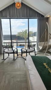 a room with two benches and a hammock in a building at Madrid Luxury Villa in Al Rama