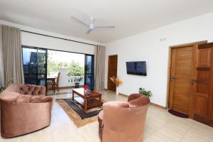 a living room with two chairs and a table at Diani Luxe Villa 1bdr A, 600m from the beach in Galu