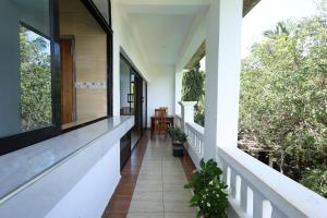a hallway of a house with windows and plants at Diani Luxe Villa 1bdr A, 600m from the beach in Galu
