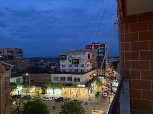 a view of a city at night at REA Apartment in Shkodër
