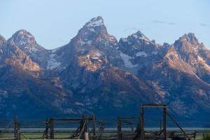 a mountain range with a fence in front of it at The Alpine House in Jackson
