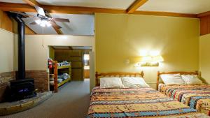 a bedroom with two beds and a fireplace at Arrowhead 04 in Red River