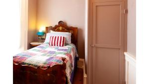 a bedroom with a bed with a quilt on it at Wyatt Earp in Cimarron