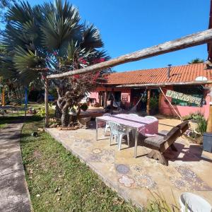 a picnic table and bench in front of a house at Pousada Santa Rita in Ouro Preto