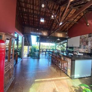 a kitchen with a counter and a bar with chairs at Pousada Santa Rita in Ouro Preto