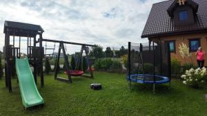 a group of playground equipment in a yard at Sosnowe Domki in Sarbinowo +102 photos