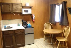 a small kitchen with a sink and a table at Arrowhead 02 in Red River