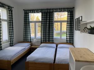 a room with three beds and two windows at Penzion Hají in Janov nad Nisou +63 photos