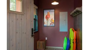 a room with a poster on the wall and a door at Bavarian Chalet 1 in Taos Ski Valley
