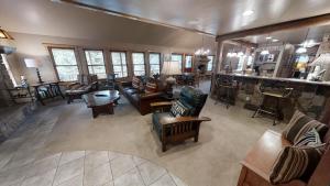 a large living room with couches and a bar at Antlers Riverside Lodge in Red River