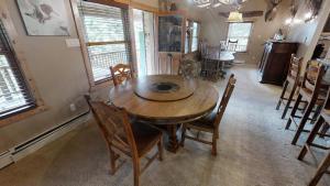 a dining room with a wooden table and chairs at Antlers Riverside Lodge in Red River +40 photos
