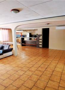a living room with a couch and a table at Spacious Family House with Pool in Afareaitu