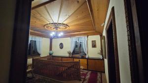an entrance to a room with a ceiling with a chandelier at Dona Guest House - Horse Riding in Koprivshtitsa