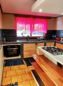 a kitchen with a sink and a stove top oven at Spacious Family House with Pool in Afareaitu