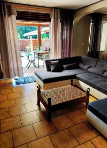 a living room with a couch and a table at Spacious Family House with Pool in Afareaitu +70 photos