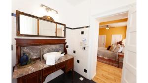 a bathroom with a sink and a mirror on a wall at William F. Cody in Cimarron