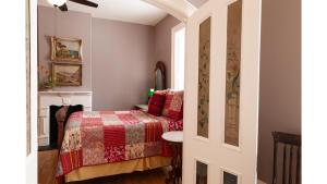 a small bedroom with a bed and a table at Bat Masterson in Cimarron