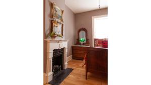 a living room with a fireplace and a mirror at Bat Masterson in Cimarron +4 photos