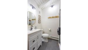a bathroom with a sink and a toilet and a mirror at Aspen Hideaway in Red River +13 photos