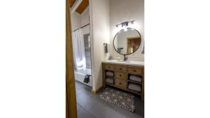 a bathroom with a sink and a mirror at Aspen Hideaway in Red River
