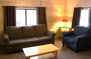 a living room with a couch and a chair and a table at Arrowhead 01 Townhouse in Red River