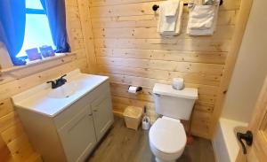 a bathroom with a white toilet and a sink at Arrowhead 01 Townhouse in Red River +12 photos