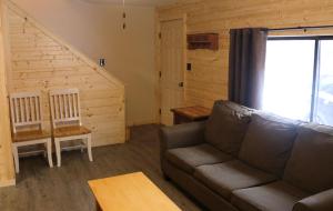 a living room with a couch and a staircase at Arrowhead 01 Townhouse in Red River