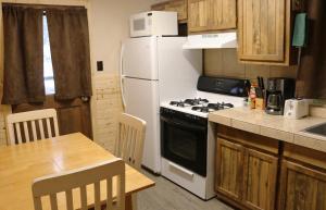 a kitchen with a stove and a white refrigerator at Arrowhead 01 Townhouse in Red River