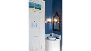 a bathroom with a sink and a mirror at Annie Oakley in Cimarron