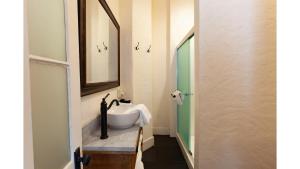 a bathroom with a sink and a mirror at Annie Oakley in Cimarron