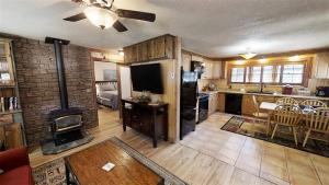 a kitchen and living room with a fireplace and a stove at Knotty & Nice in Red River