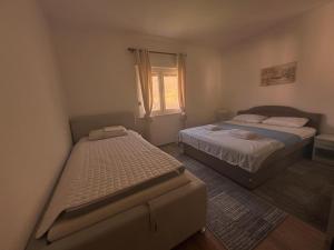 a bedroom with two beds and a window at Villa Ramea in Kovačevo Polje