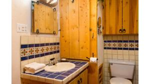 a bathroom with a sink and a toilet at Denton Cabin in Taos Ski Valley