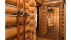 a hallway in a log cabin with a wooden wall at Denton Cabin in Taos Ski Valley