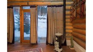 a room with a sliding glass door in a log cabin at Denton Cabin in Taos Ski Valley +14 photos