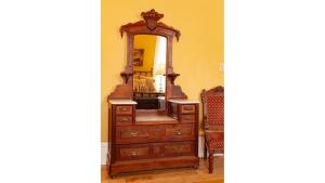 a wooden dresser with a mirror on top of it at Pancho Griego in Cimarron