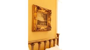 a painting hanging on a wall next to a staircase at Pancho Griego in Cimarron
